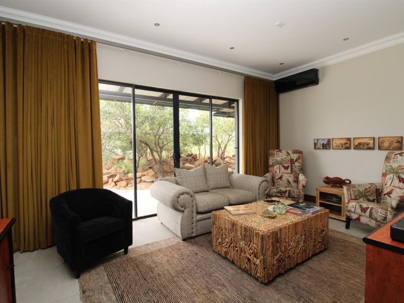 A comfortable living room featuring large sliding glass doors that provide natural light and direct access to the outdoor patio area.