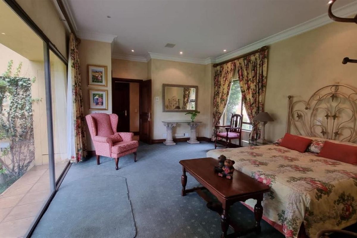 Spacious bedroom featuring large sliding glass doors leading to a private patio, recessed ceiling lighting, and crown molding.