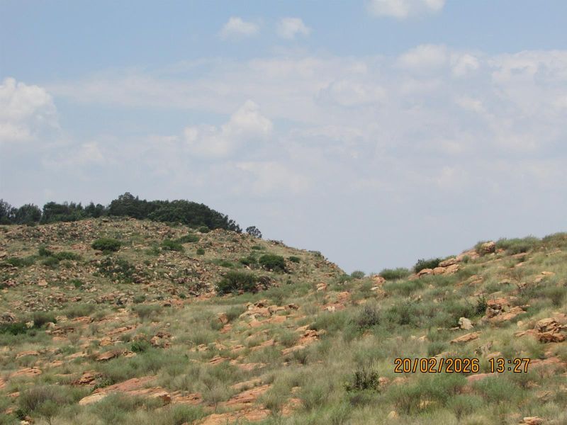 A scenic view of the natural rocky landscape and vegetation on the farm property.