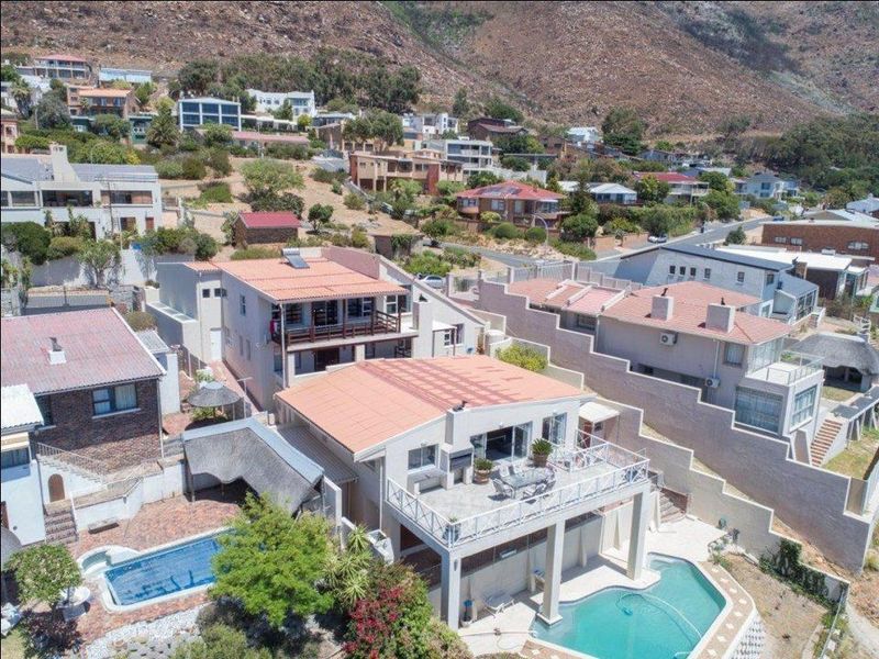 Aerial view of the property showcasing the multi-level layout, swimming pool, elevated patio area, and surrounding residential neighbourhood.