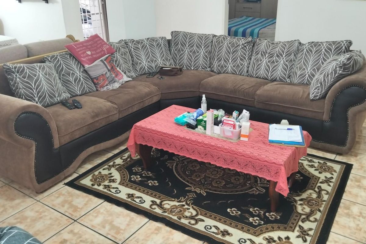 A living room area featuring tiled flooring, providing a functional space for relaxation and daily living.