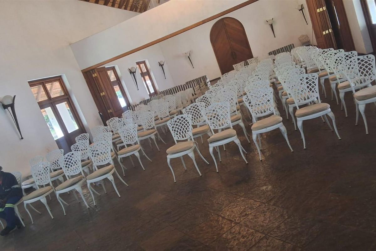 Spacious hall featuring high vaulted ceilings, tiled flooring, and arched wooden doors, suitable for events or large gatherings.