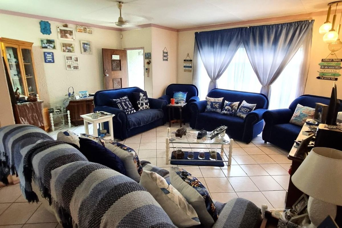A spacious living room featuring tiled flooring and a ceiling fan, offering a comfortable and functional area for relaxation.