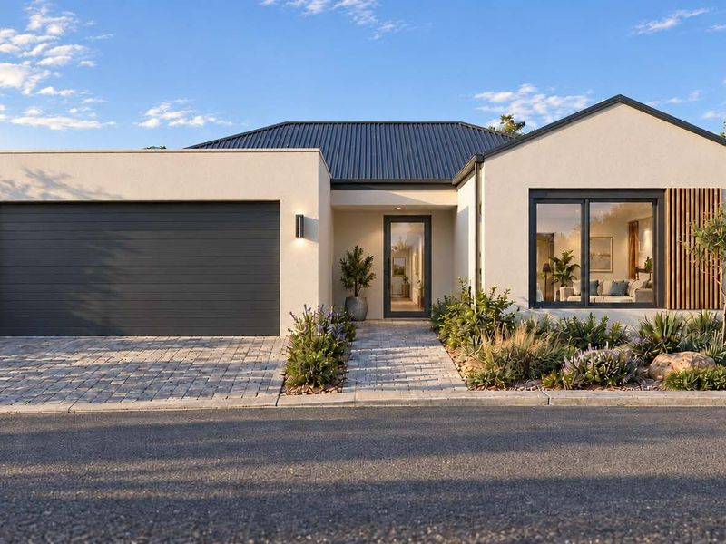 Modern single-story residential facade featuring a double garage, paved driveway, landscaped garden, and contemporary architectural finishes.