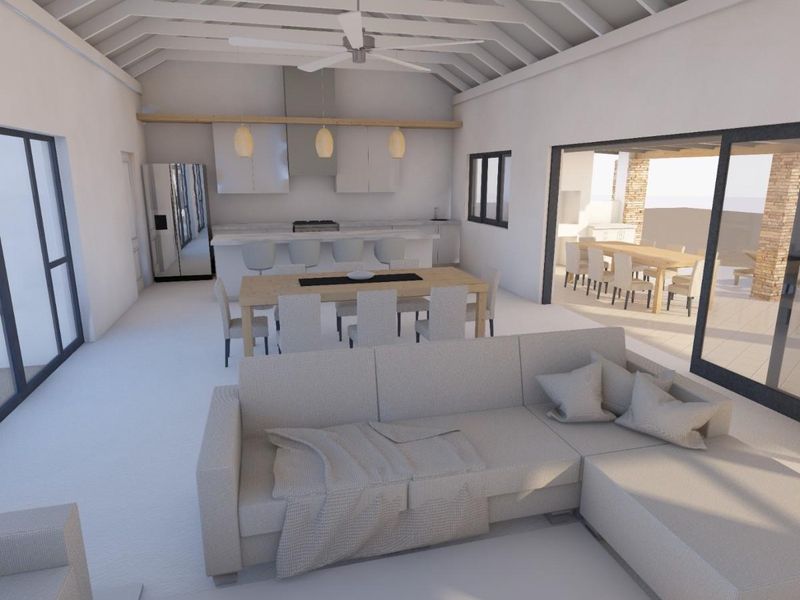 Spacious open-plan living and kitchen area featuring a high vaulted ceiling with exposed rafters, modern kitchen island, and large sliding doors leading to a patio.