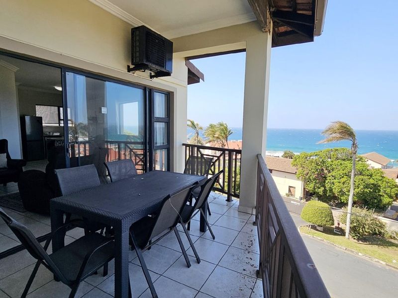 Spacious covered balcony featuring tiled flooring, a built-in air conditioning unit, and expansive ocean views, perfect for outdoor relaxation.