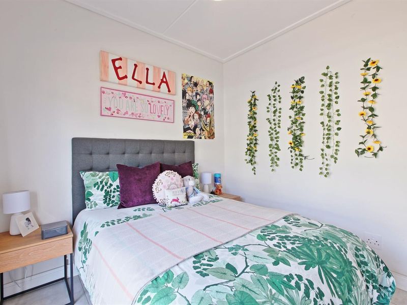 A well-maintained bedroom featuring neutral walls, clean flooring, and standard electrical fixtures, providing a comfortable and functional living space.