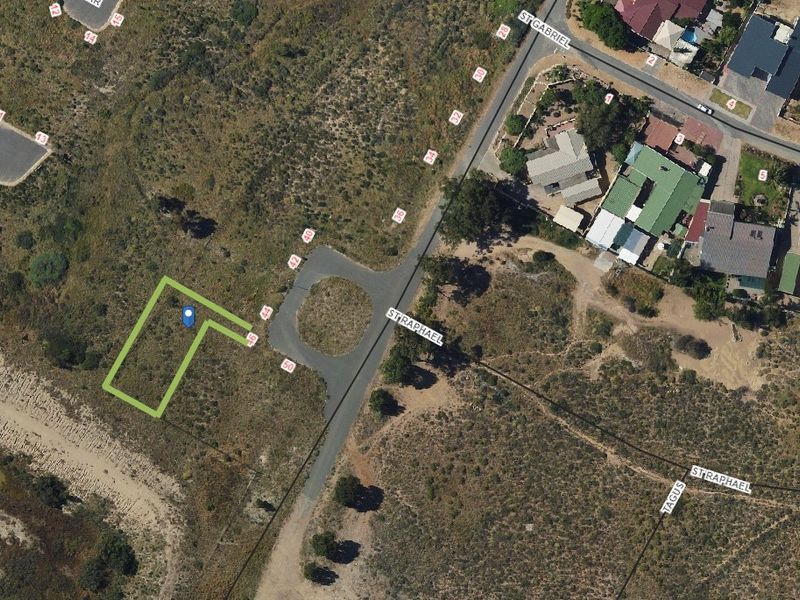 Aerial view of a vacant residential land plot with road access in a developing neighborhood.