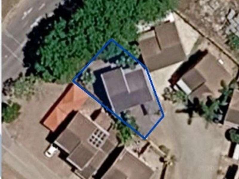 An aerial satellite view showing the property footprint and roof structure within its residential context.