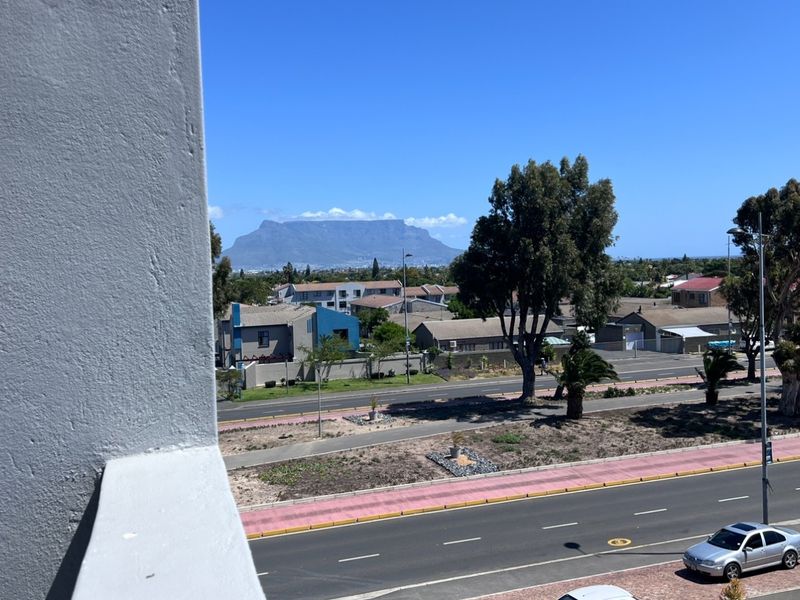 Elevated view overlooking the surrounding neighbourhood with a clear perspective of Table Mountain in the distance.