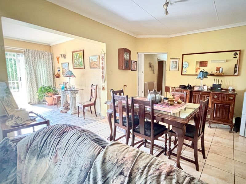 Open plan living and dining area featuring tiled flooring and direct access to an outdoor patio through sliding glass doors.