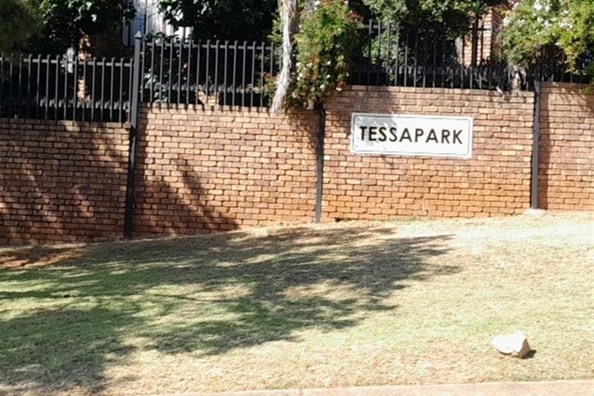 A view of the brick boundary wall and metal security fencing at the entrance of the Tessapark estate.