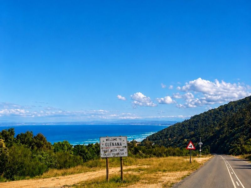 A scenic street view showing the approach to the area with coastal landscape views and clear road infrastructure.