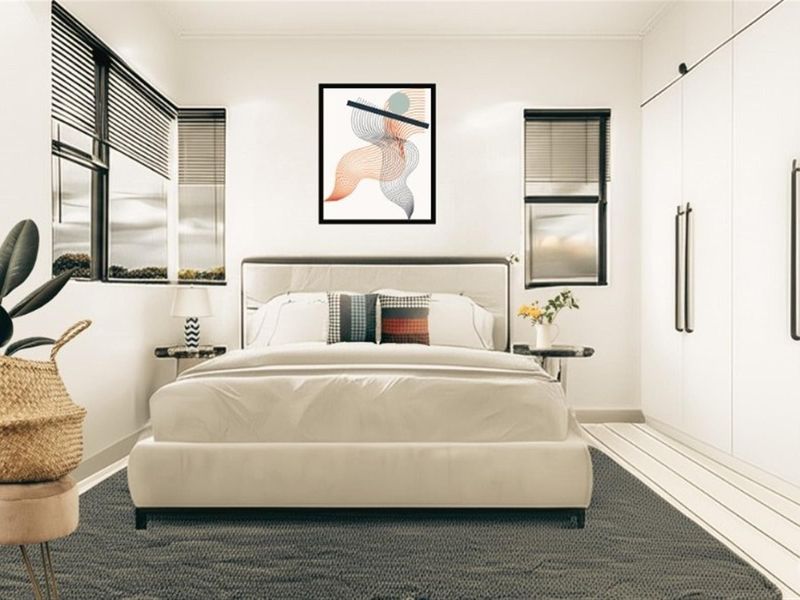 A modern, well-lit bedroom featuring built-in cupboards and venetian blinds, presenting a clean and contemporary aesthetic.