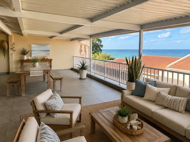 Spacious covered balcony featuring tiled flooring, metal balustrades, and expansive ocean views, providing an ideal setting for outdoor relaxation and entertaining.