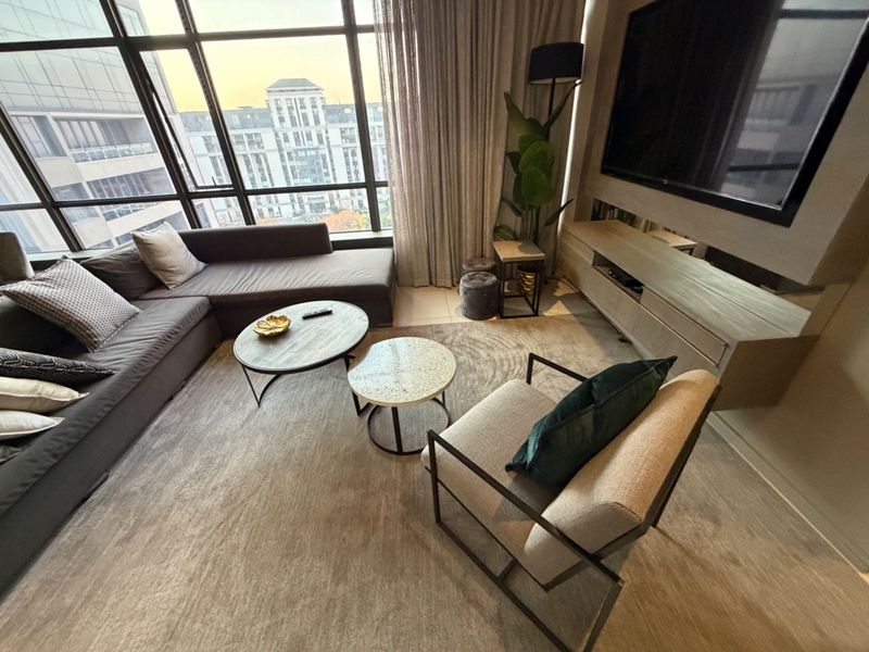 Modern living room featuring floor-to-ceiling windows with urban views and a custom built-in media console.