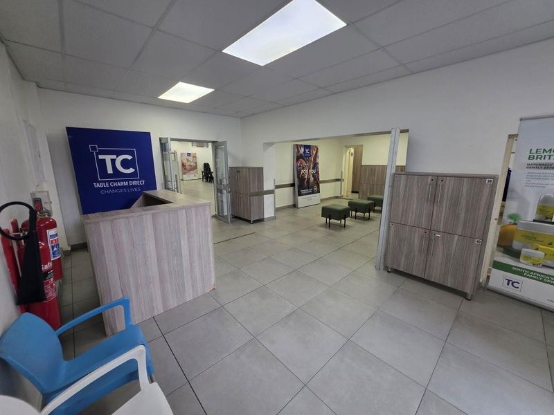 Commercial reception area featuring a built-in desk, tiled flooring, recessed lighting, and integrated storage cabinetry.