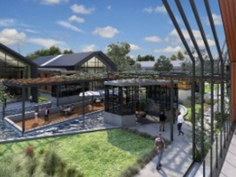A modern architectural rendering of a landscaped outdoor courtyard area featuring pergolas, paved walkways, and contemporary building structures.