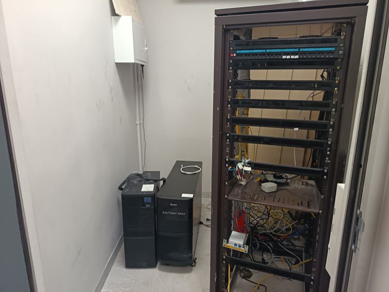 A dedicated utility room housing server rack infrastructure, uninterruptible power supply units, and electrical distribution components.