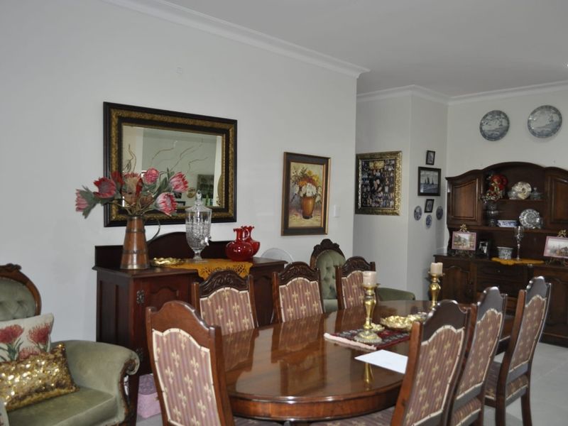 A formal dining room featuring coved ceilings and recessed lighting, providing a traditional space for family meals and entertaining.