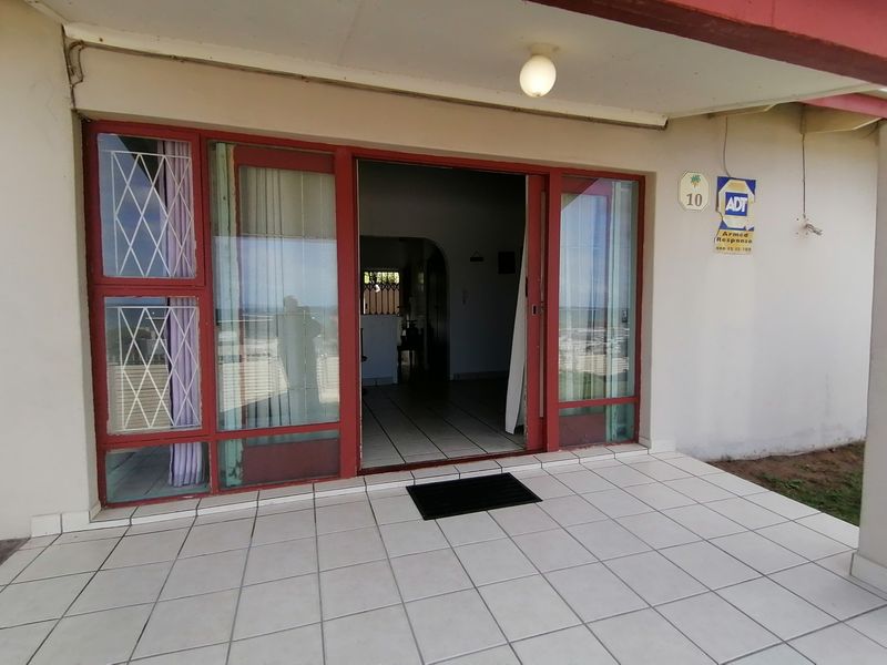 Covered patio area featuring tiled flooring and sliding glass doors providing access to the interior living space.