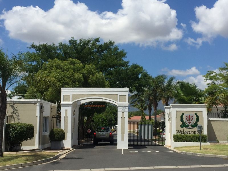 The secure entrance gate and gatehouse of the Welgevonden estate, featuring controlled access and established landscaping.