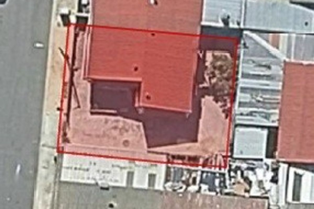 An aerial view of the property showing the roof structure and site boundary.