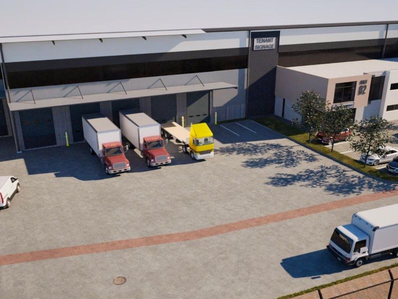 Aerial view of a modern industrial warehouse facility featuring multiple loading docks, roller shutter doors, and a spacious paved yard area.