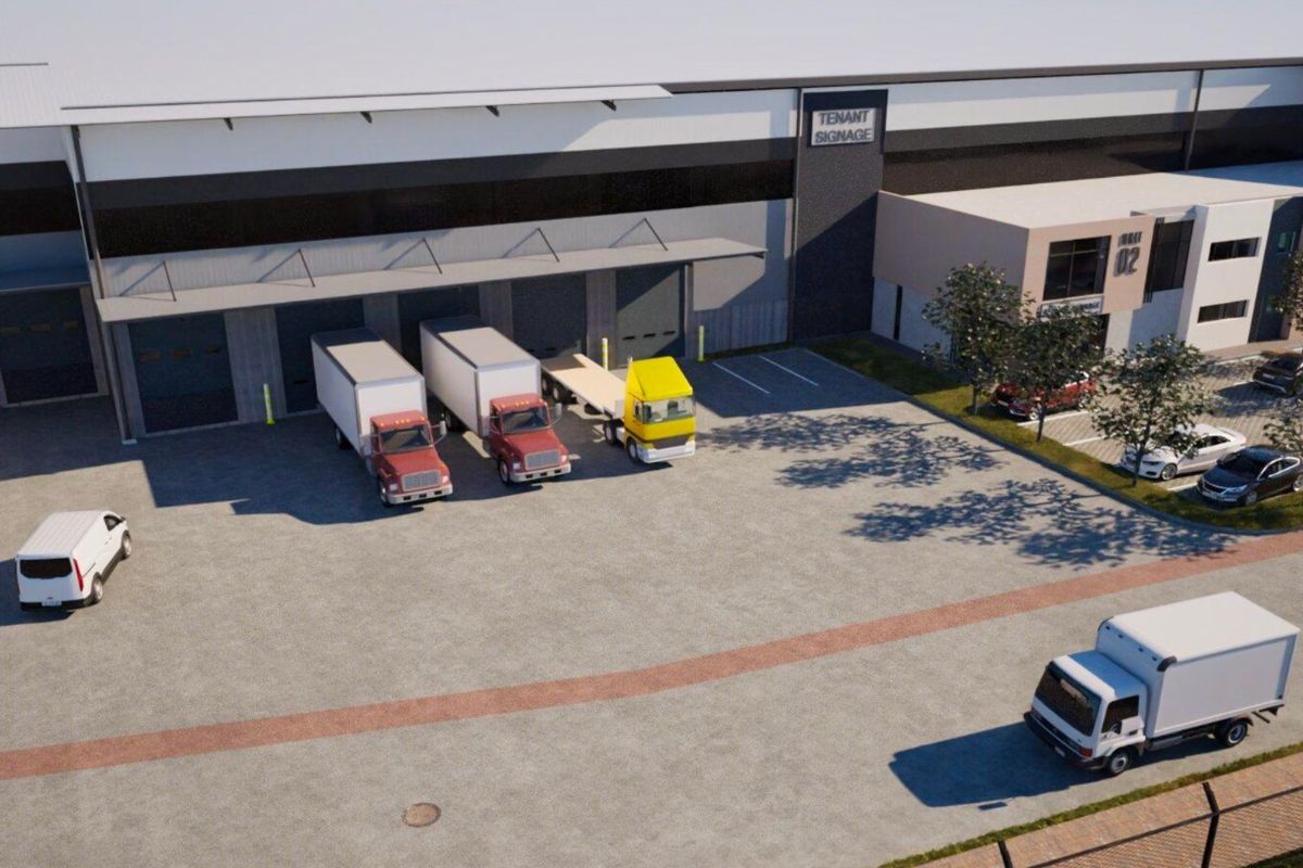 Aerial view of a modern industrial warehouse facility featuring multiple loading docks, roller shutter doors, and a spacious paved yard area.