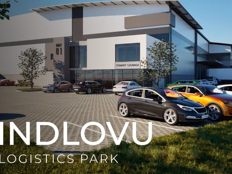Modern industrial logistics park facility featuring a paved parking area, contemporary facade design, and prominent tenant signage.