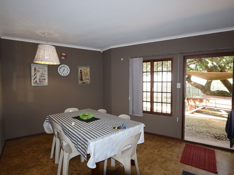 Dining room featuring cork flooring, coved ceilings, and direct access to an outdoor patio area through a sliding door.
