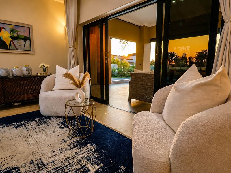 A well-lit living room featuring large sliding glass doors that provide seamless access to an outdoor patio area.