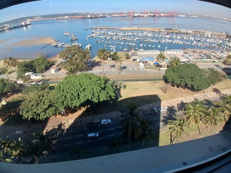 Elevated panoramic view overlooking the harbor, marina, and surrounding coastal landscape from the apartment.