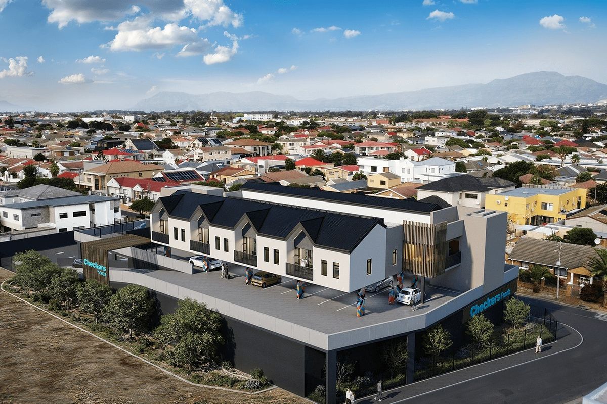 Aerial view of a modern multi-level residential and commercial development featuring a pitched roof design and integrated parking facilities.