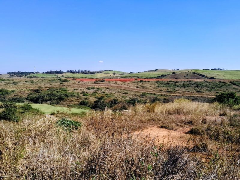 Expansive view of the surrounding natural landscape and rolling hills, showcasing the open terrain of the vacant residential land.