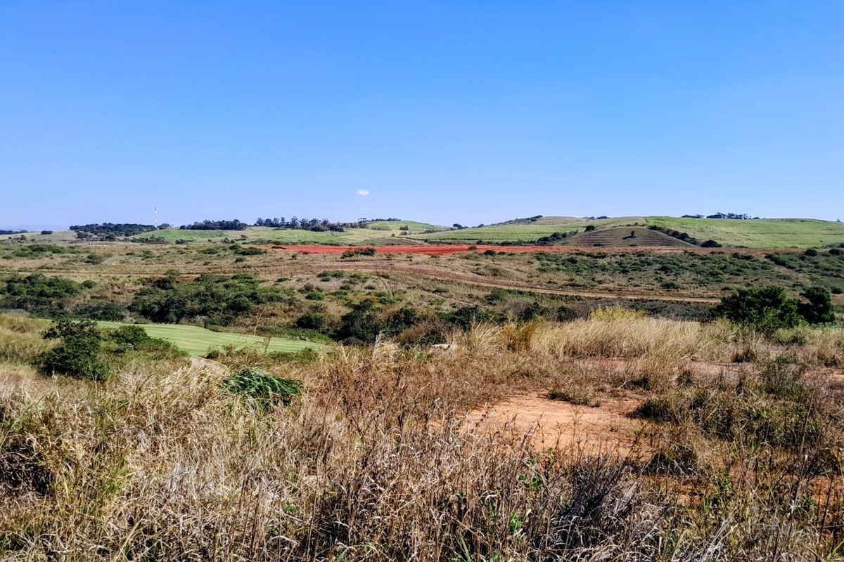 Expansive view of the surrounding natural landscape and rolling hills, showcasing the open terrain of the vacant residential land.