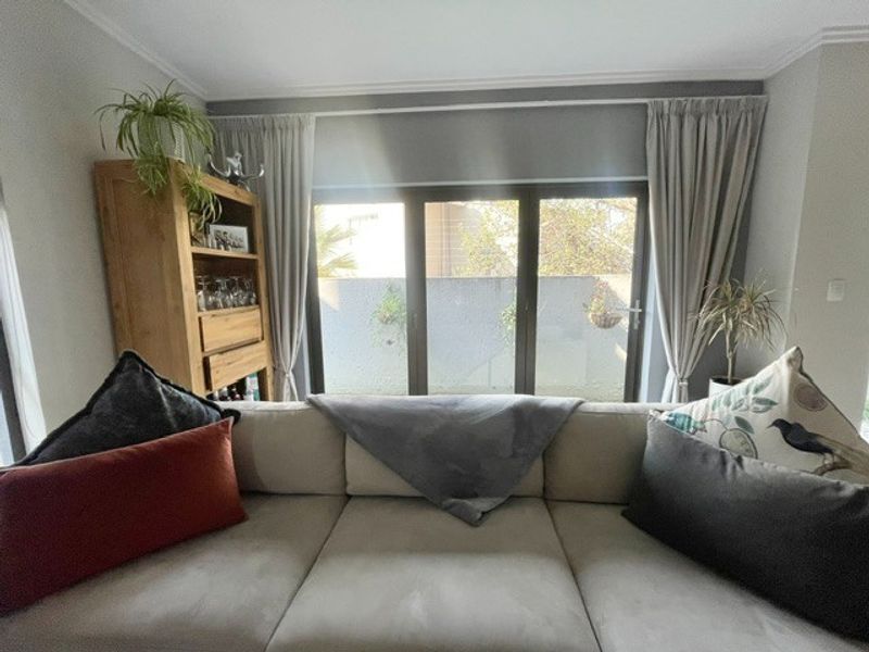 A comfortable living room featuring large sliding glass doors that provide natural light and access to the outdoor area.