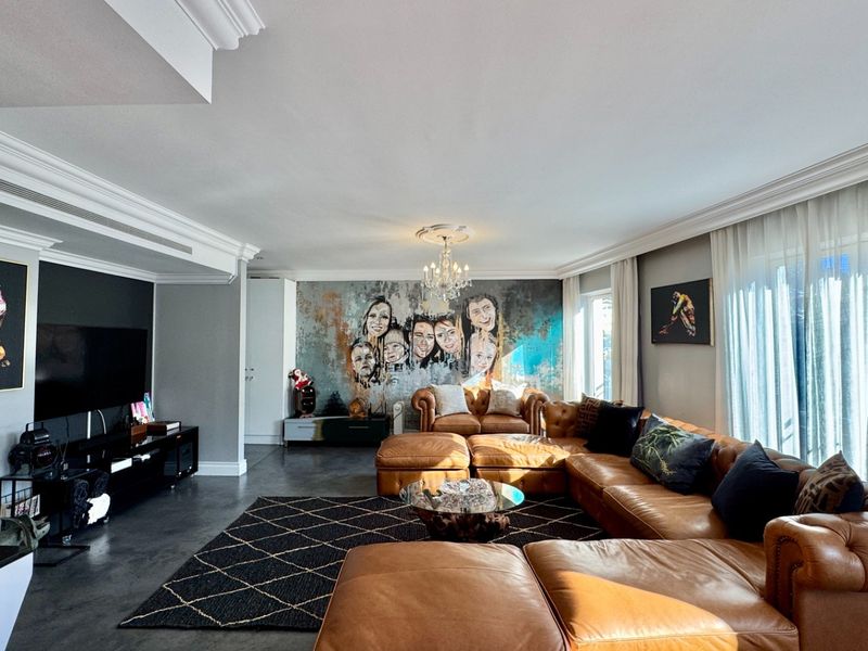Spacious and well-appointed living room featuring elegant crown molding, recessed lighting, ducted air conditioning, and large format floor tiles.