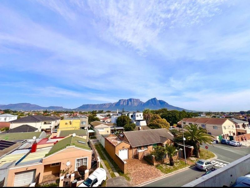Elevated panoramic view overlooking the surrounding residential neighbourhood with a prominent mountain range in the background.