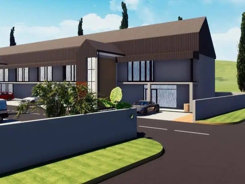 A digital architectural rendering of a modern residential building facade featuring a pitched roof design and a paved driveway.