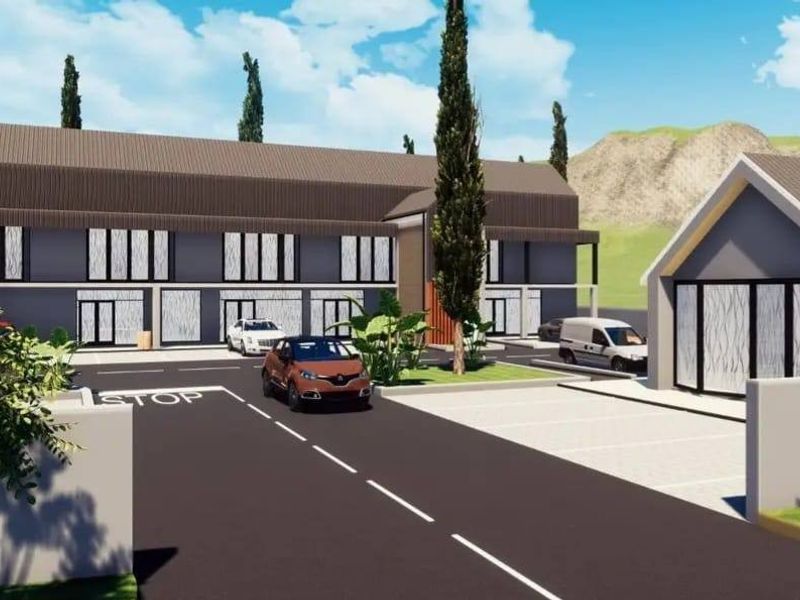 A digital architectural rendering of a modern residential complex featuring paved driveways, designated parking bays, and contemporary building facades.