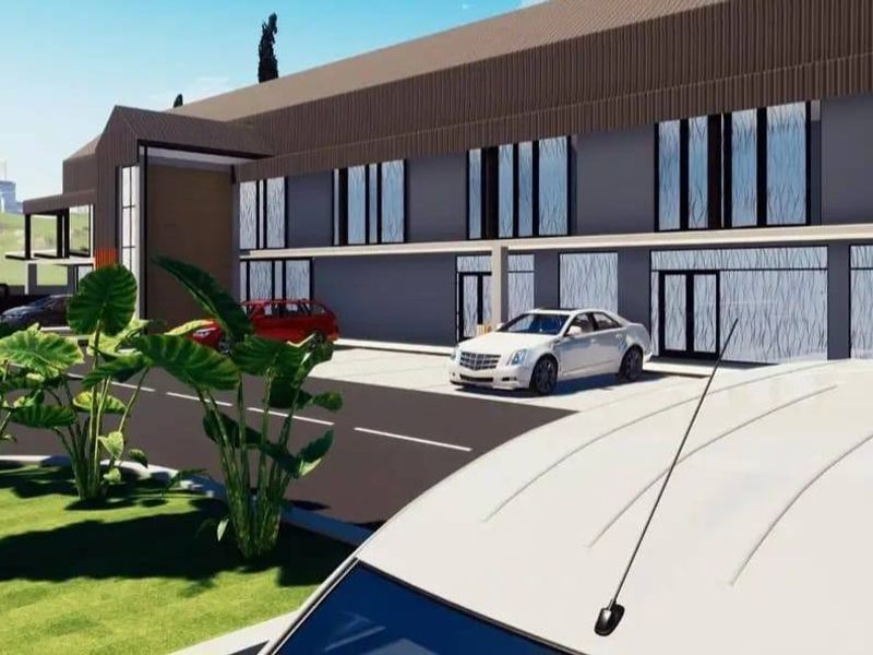 A digital architectural rendering of a modern residential building exterior featuring a paved driveway and landscaped grounds.