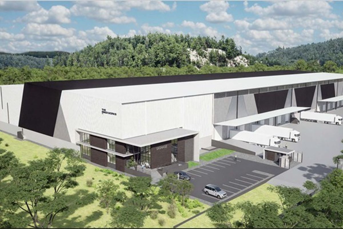 Aerial perspective of a modern industrial warehouse facility featuring multiple loading docks, dedicated parking, and a secure entrance gatehouse.
