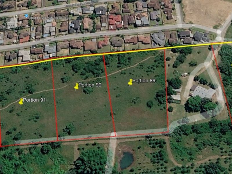 Aerial view of a residential land development site showing multiple subdivided portions with boundary lines overlaid on the landscape.