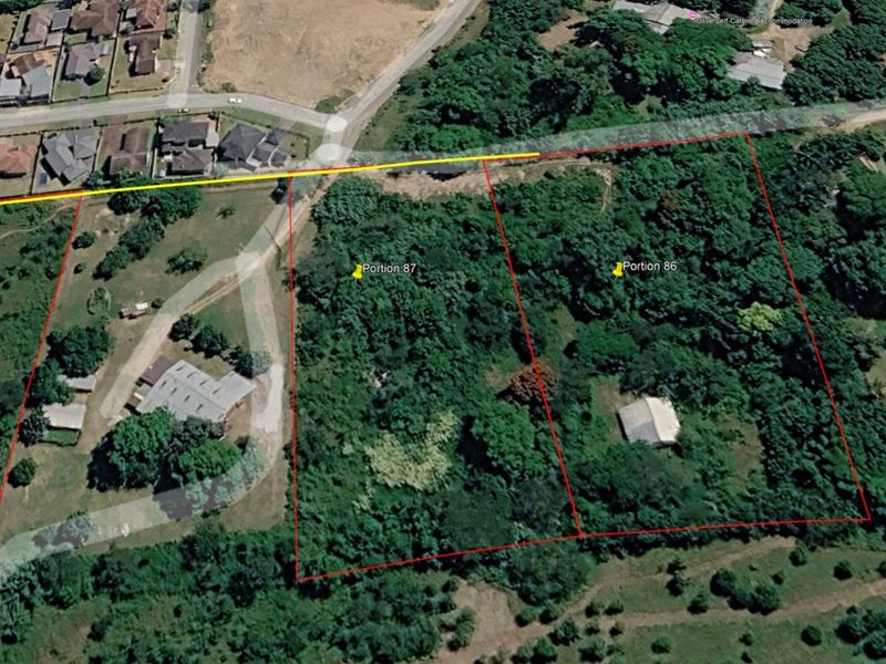 Aerial view of vacant residential land parcels, identified as Portion 86 and 87, featuring dense vegetation and surrounding neighborhood infrastructure.