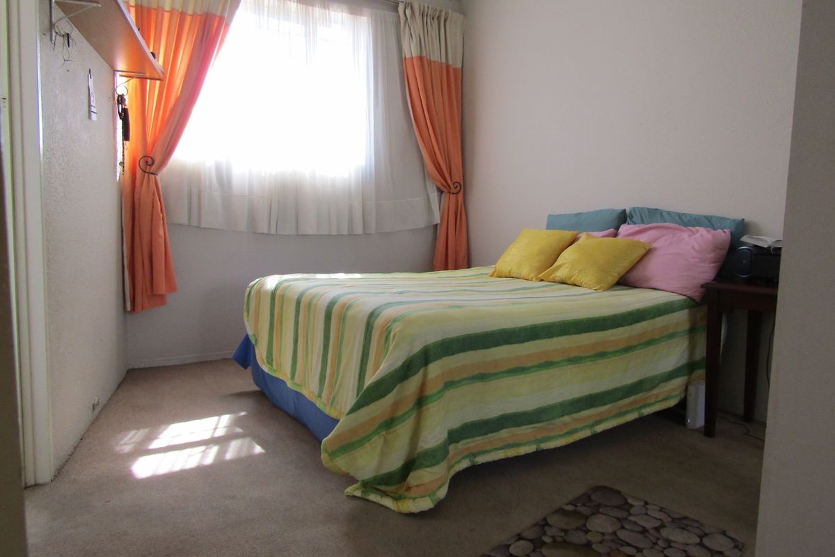 A standard bedroom featuring carpeted flooring and neutral wall finishes, providing a functional and comfortable living space.