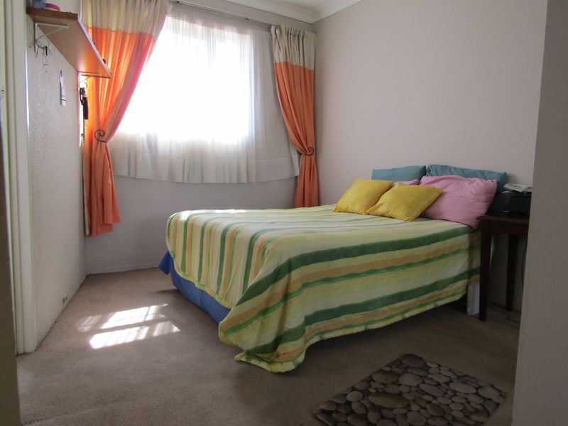 A standard bedroom featuring carpeted flooring and neutral wall finishes, providing a functional and comfortable living space.
