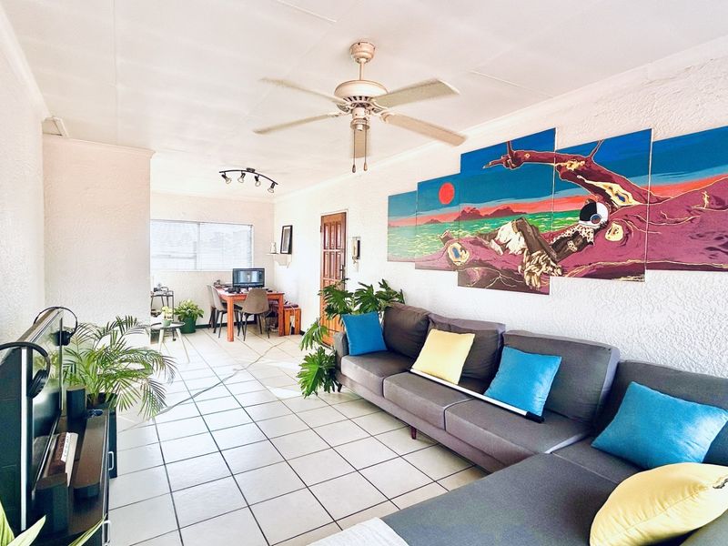 Open plan living and dining area featuring ceramic tile flooring, a ceiling fan, and track lighting.