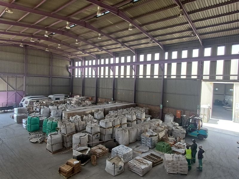 Spacious industrial warehouse featuring a high-clearance steel portal frame, corrugated metal walls, and large access doors suitable for logistics or manufacturing operations.