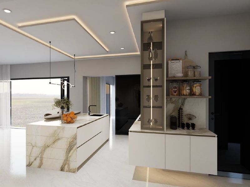 Modern kitchen featuring a marble-topped island, sleek integrated cabinetry, built-in display shelving, and sophisticated recessed ceiling lighting.